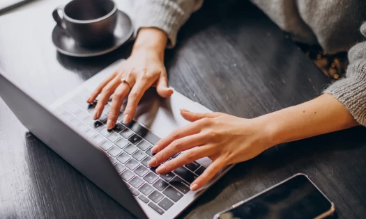 Typing on a laptop