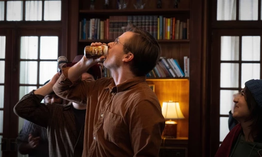 A man drinks MUG Root Beer