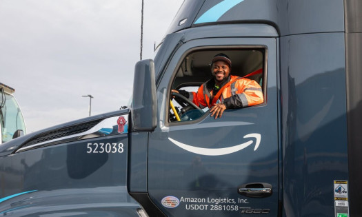 An African-American man inside an Amazon delivery truck