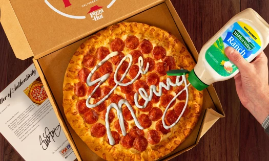 A Pizza Hut pizza signed by Eli Manning using Hidden Valley Ranch