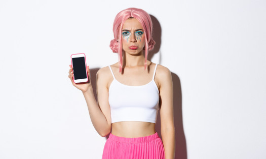 Sulking girl holding a smartphone