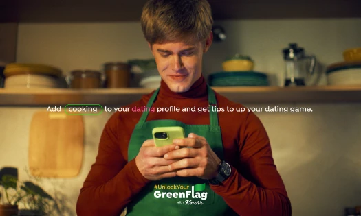 Man standing in the kitchen while on his phone