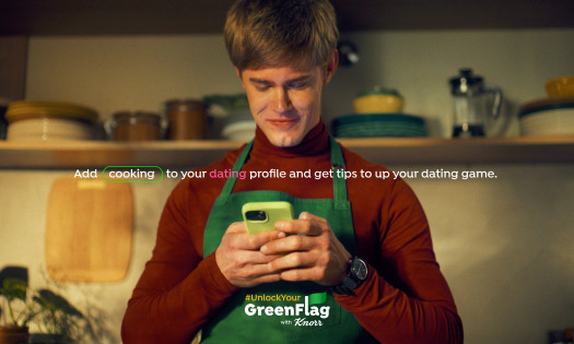 Man standing in the kitchen while on his phone