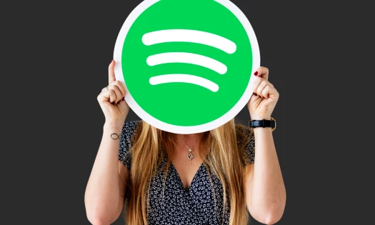 Woman holding on to the Spotify logo