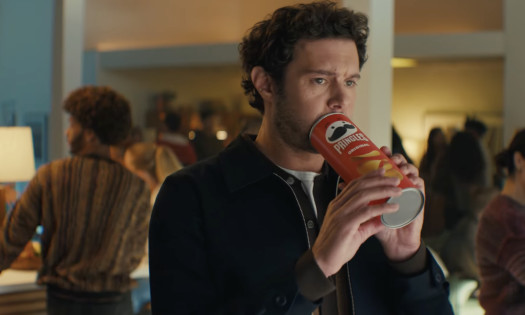 Adam Brody blowing into a can of Pringles