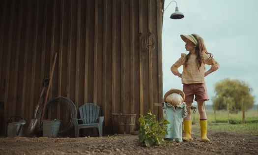 A little girl takes care of her crop
