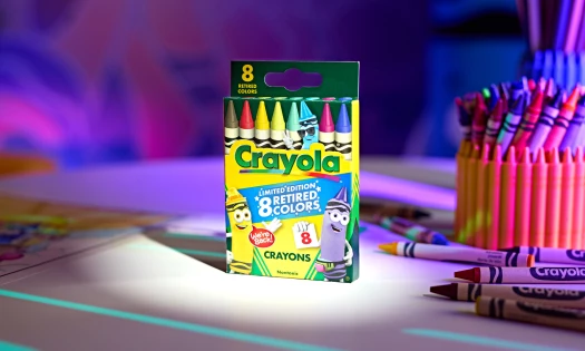 A box of Crayola's retired crayon colors on a desk