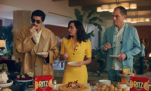 Aubrey Plaza, Bad Bunny, and Michael Shannon at a snack table