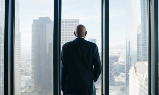 Morgan Freeman looks outside a window