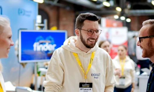 Participants of the E-commerce Berlin Expo interacting with each other at a booth