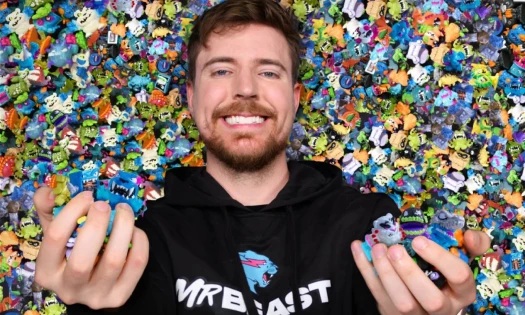MrBeast lying down on a pile of Lab Micro Beast toys