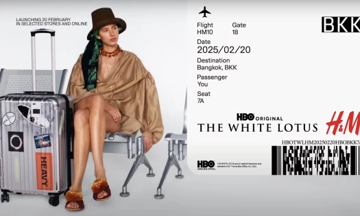 A woman waiting at the airport wearing H&M x The White Lotus collection