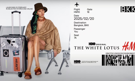 A woman waiting at the airport wearing H&M x The White Lotus collection