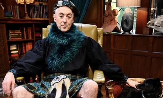 'The Traitors' host Alan Cummings wearing a Scottish outfit with a black dog