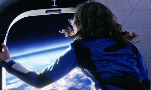 Female astronaut looking out the space shuttle to Earth