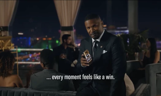 Jamie Foxx sitting and using the BetMGM app