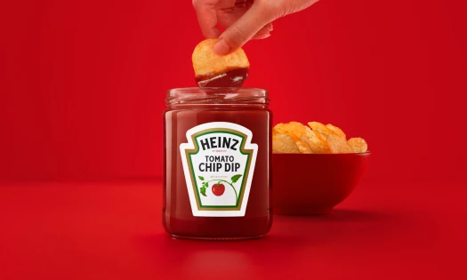 Potato chips dipped in Heinz Tomato Chip Dip