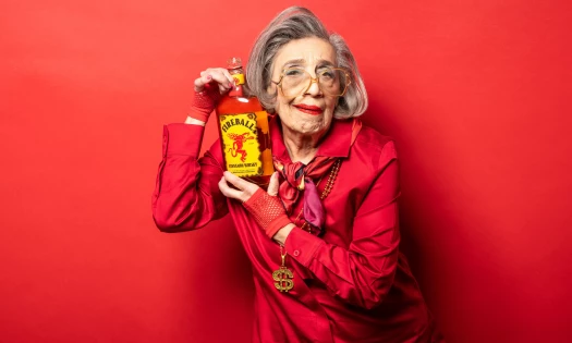 A senior posing with Fireball Whisky