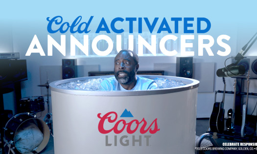 An announcer sits in a giant Coors Light ice bath