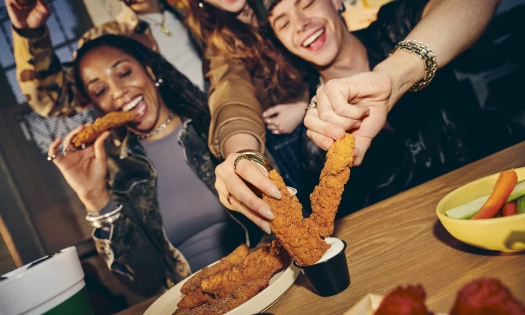 Customers enjoying Wingstop's new chicken tenders