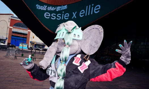 Ellie the Elephant wearing and holding an essie nail polish