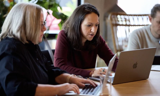 Women typing on laptops