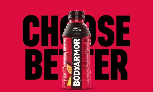 The new BODYARMOR packaging with the bottles displayed on a football field