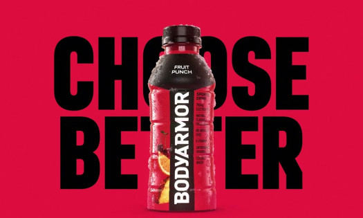 The new BODYARMOR packaging with the bottles displayed on a football field