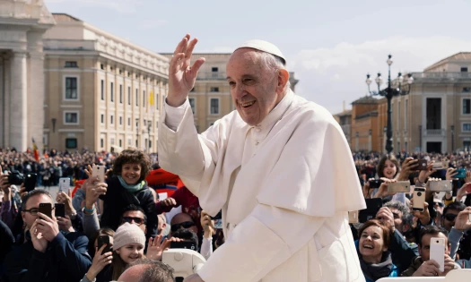 Pope Francis smiles as he greets Catholic devotees in Vatican City in 2018