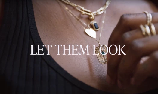 A closeup of necklaces and rings worn by a woman with the text: Let Them Look