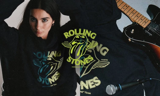 A model wearing a Rolling Stones hoodie with mic and guitar graphics