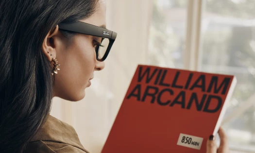A woman wearing smart glasses reading a book