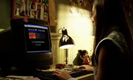 A woman in front of a desktop computer
