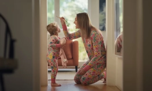 A mom measuring her toddler's height on a wall