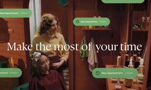 A hair stylist working on her client's hair with green notification messages showing her appointments and the text: "Make the most of your time"