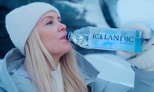 A woman drinking from a bottle of Icelandic Glacial Water