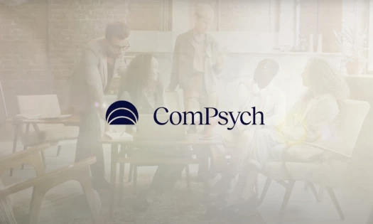 ComPsych's new logo against a faded backdrop of a group of officemates chatting