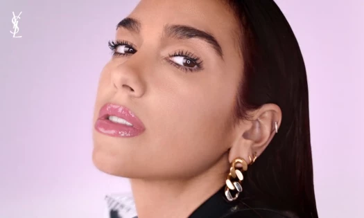 Dua Lipa looking at the camera in YSL's new beauty ad