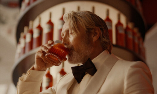 Mads Mikkelsen drinking a cocktail in Campari's latest ad