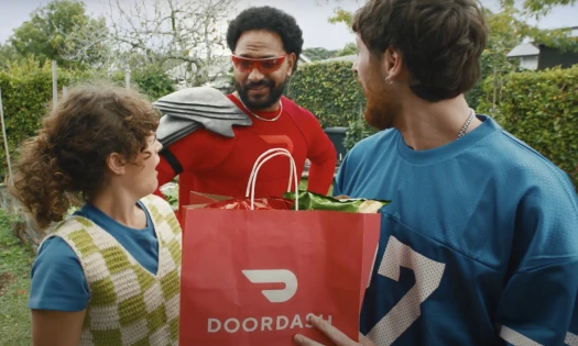 Superhero 'Dash' in red with two friends holding a DoorDash paper bag