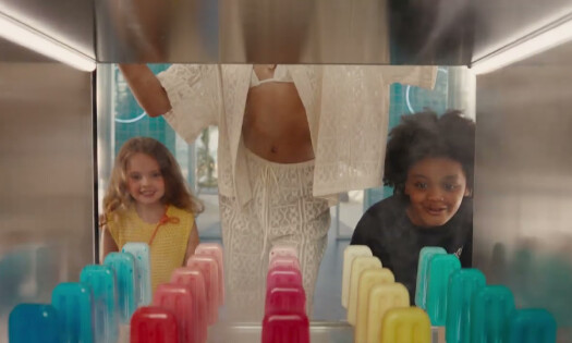 Two kids excitedly look at colorful ice pops