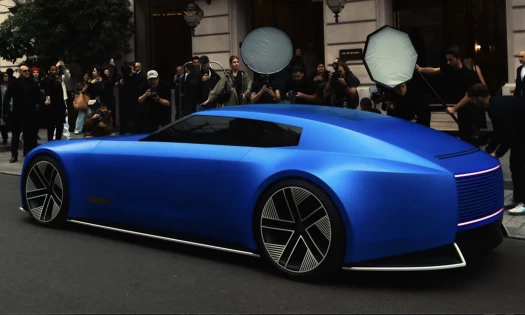 The Jaguar Type 00 in Ultramarine Blue in a street in Paris with photographers flocking to take a photo
