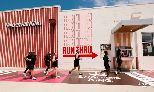 Runners pass by Smoothie King's new 'Run-Thru' activation