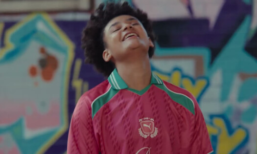 An athlete smiling while wearing a PUMA jersey