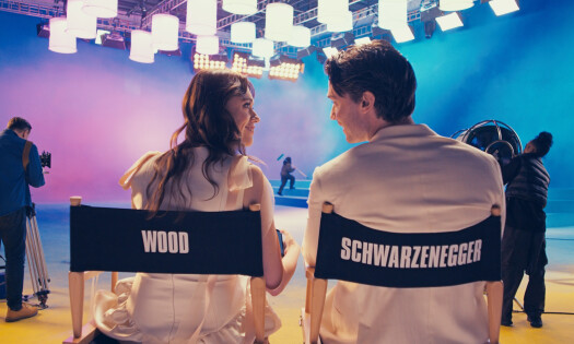 The 'White Lotus' actors sit in director's chairs with 'Wood' and 'Shwarzenegger' in the back