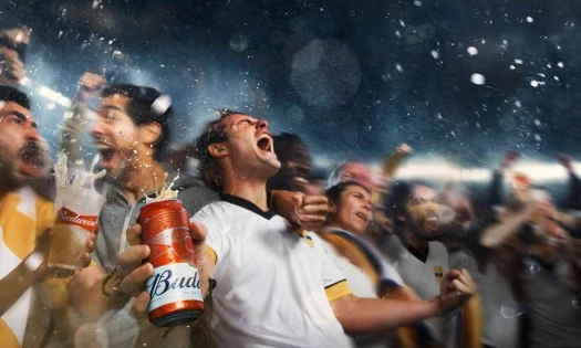 A man celebrating with a can of Budweiser on hand