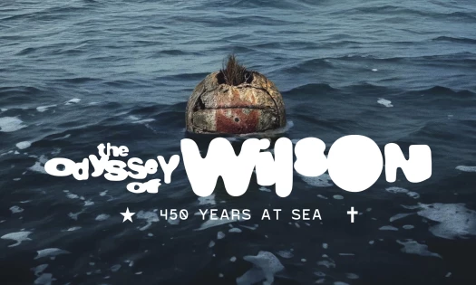 Wilson, the volleyball from Tom Hanks' "Cast Away," is seen in the ocean with the text: "The Odyssey of Wilson: 450 Years At Sea"