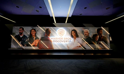 The Warner Bros. Discovery logo on an poster with famous characters like Superman for its 2025 Upfronts