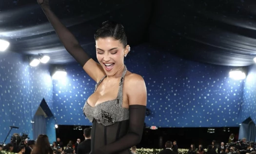 Kylie Jenner wearing a cleavage-bearing black and silver gown at the 2025 Met Gala