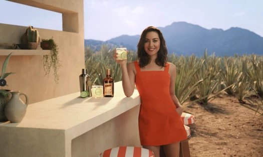 Aubrey Plaza holding up a glass of tequila